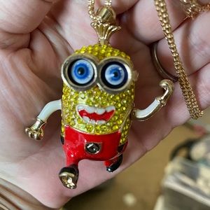 Minion wearing red bibs. Moveable arms…